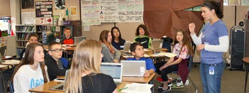 Students in classroom looking at teacher 
